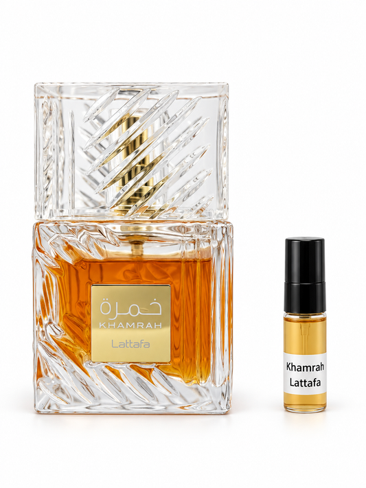 Lattafa Khamrah fragrance bottle and black-capped sample vial on white