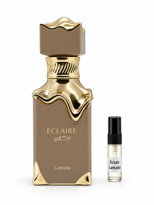 Lattafa Eclaire fragrance bottle and black-capped sample vial on white