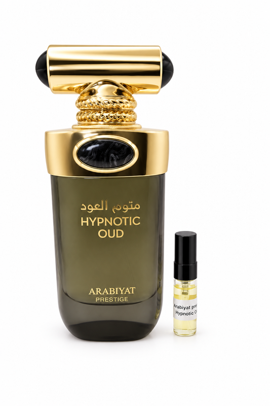 Arabiyat Prestige Hypnotic Oud fragrance bottle and black-capped sample vial on white