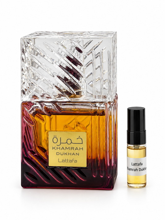 Lattafa Khamrah Dukhan fragrance bottle and black-capped sample vial on white
