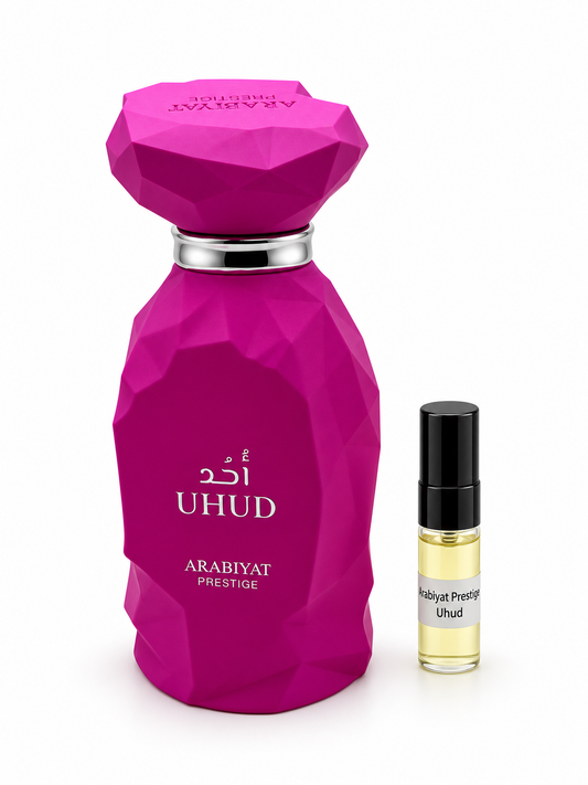 Arabiyat Prestige Uhud fragrance bottle and black-capped sample vial on white