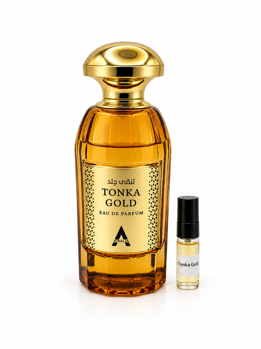 Atralia Tonka Gold fragrance bottle and black-capped sample vial on white