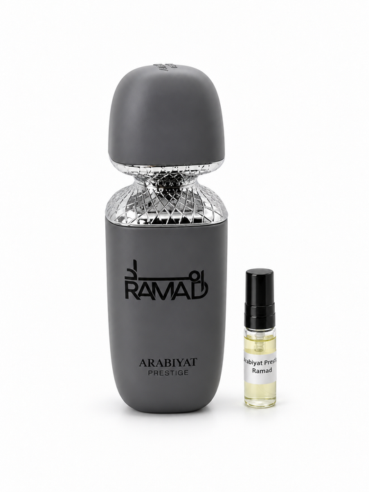 Arabiyat Prestige Ramad fragrance bottle and black-capped sample vial on white