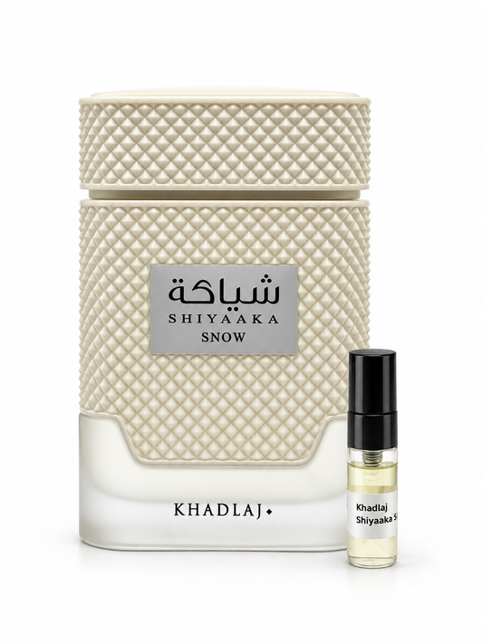 Khadlaj Shiyaaka Snow fragrance bottle and black-capped sample vial on white