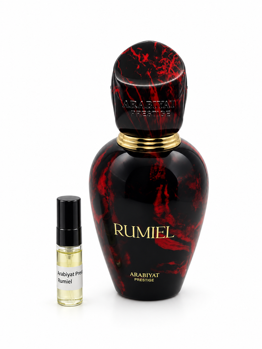 Arabiyat Prestige Rumiel fragrance bottle and black-capped sample vial on white