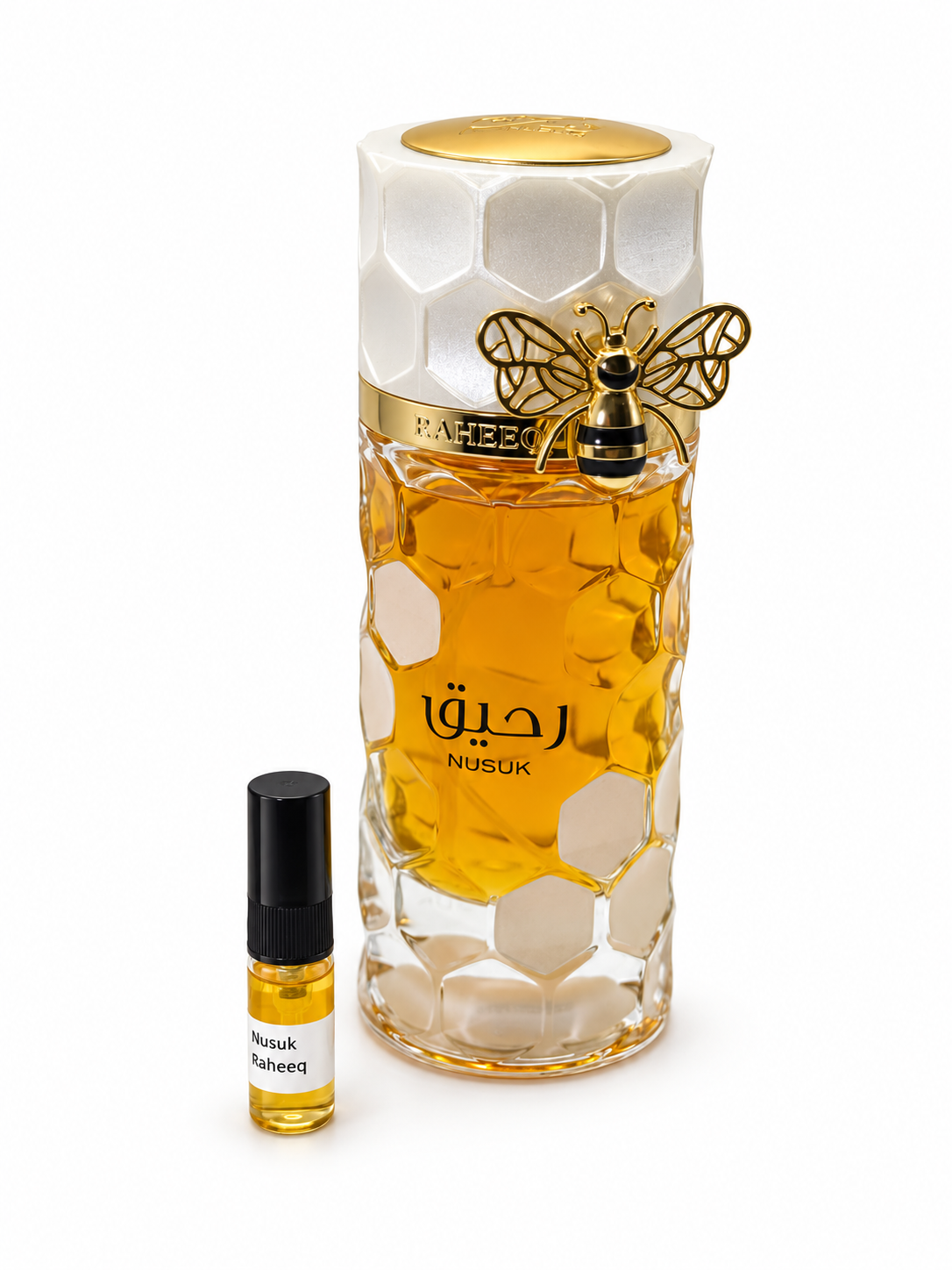 Nusuk Raheeq fragrance bottle and black-capped sample vial on white