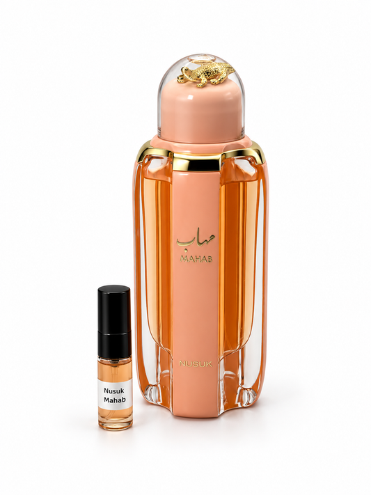 Nusuk Mahab fragrance bottle and black-capped sample vial on white