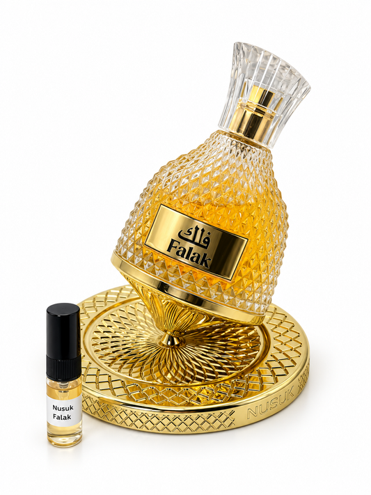 Nusuk Falak fragrance bottle and black-capped sample vial on white