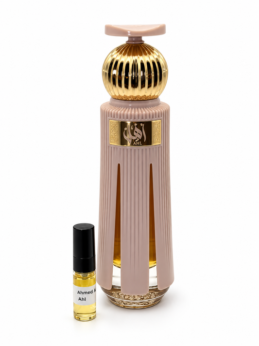 Ahmed Al Maghribi Ahl fragrance bottle and black-capped sample vial on white
