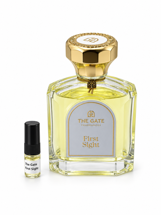 The Gate Fragrances First Sight fragrance bottle and black-capped sample vial on white