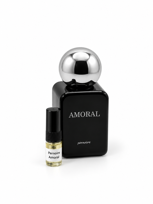 Pernoire Amoral fragrance bottle and black-capped sample vial on white