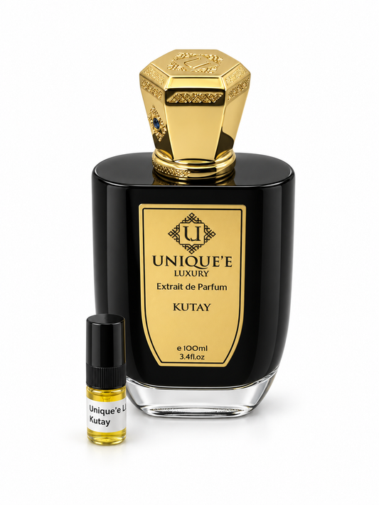 Unique'e Luxury Kutay fragrance bottle and black-capped sample vial on white