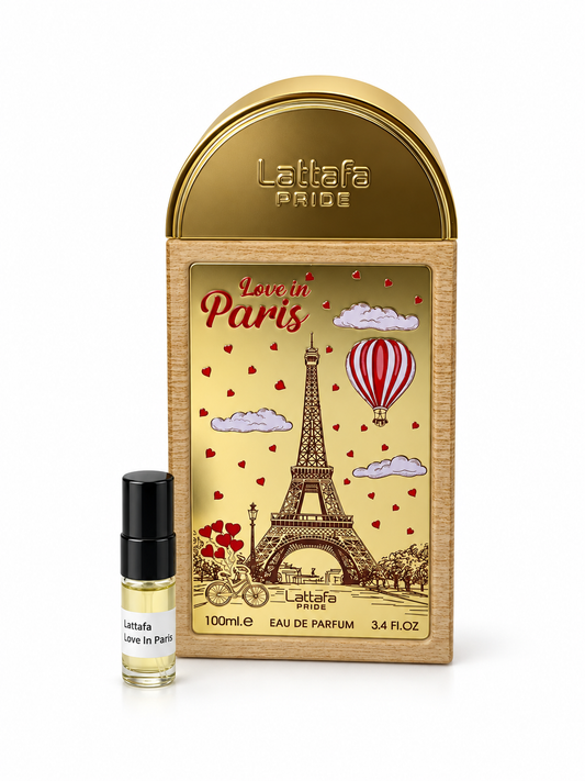 Lattafa Pride Love In Paris fragrance bottle and black-capped sample vial on white