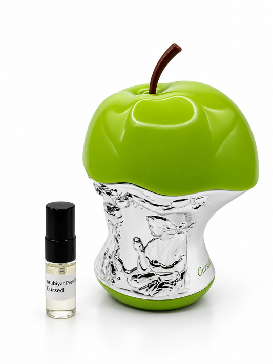 Arabiyat Prestige Cursed fragrance bottle and black-capped sample vial on white