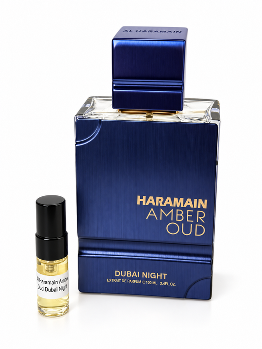 Al Haramain Amber Oud Dubai Night fragrance bottle and black-capped sample vial on white