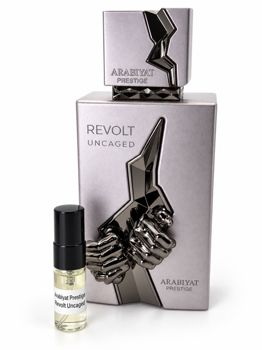 Arabiyat Prestige Revolt Uncaged fragrance bottle and black-capped sample vial on white
