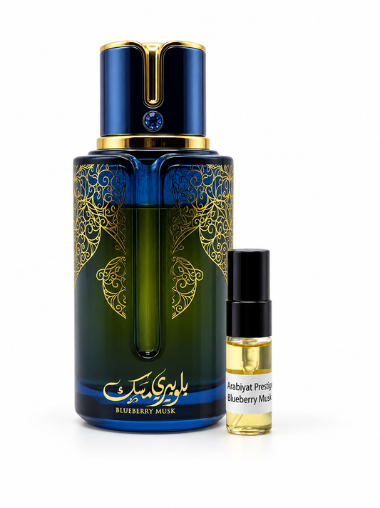Arabiyat Prestige Blueberry Musk fragrance bottle and black-capped sample vial on white