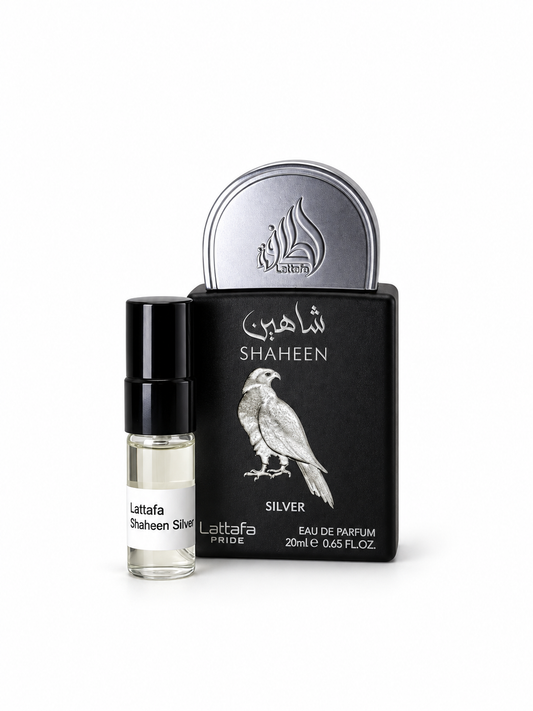 Lattafa Pride Shaheen Silver fragrance bottle and black-capped sample vial on white
