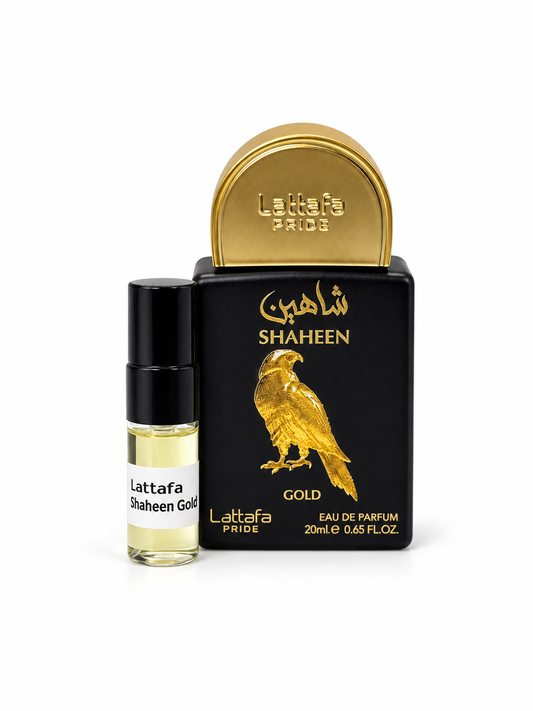 Lattafa Pride Shaheen Gold fragrance bottle and black-capped sample vial on white