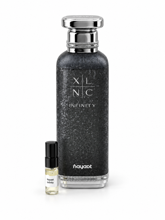 Nayaat XLNC Infinity fragrance bottle and black-capped sample vial on white