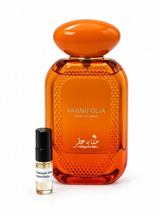 Hekayat Attar Vannifolia fragrance bottle and black-capped sample vial on white
