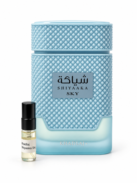 Khadlaj Shiyaaka Sky fragrance bottle and black-capped sample vial on white