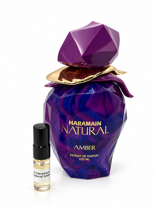 Al Haramain Natural Amber fragrance bottle and black-capped sample vial on white