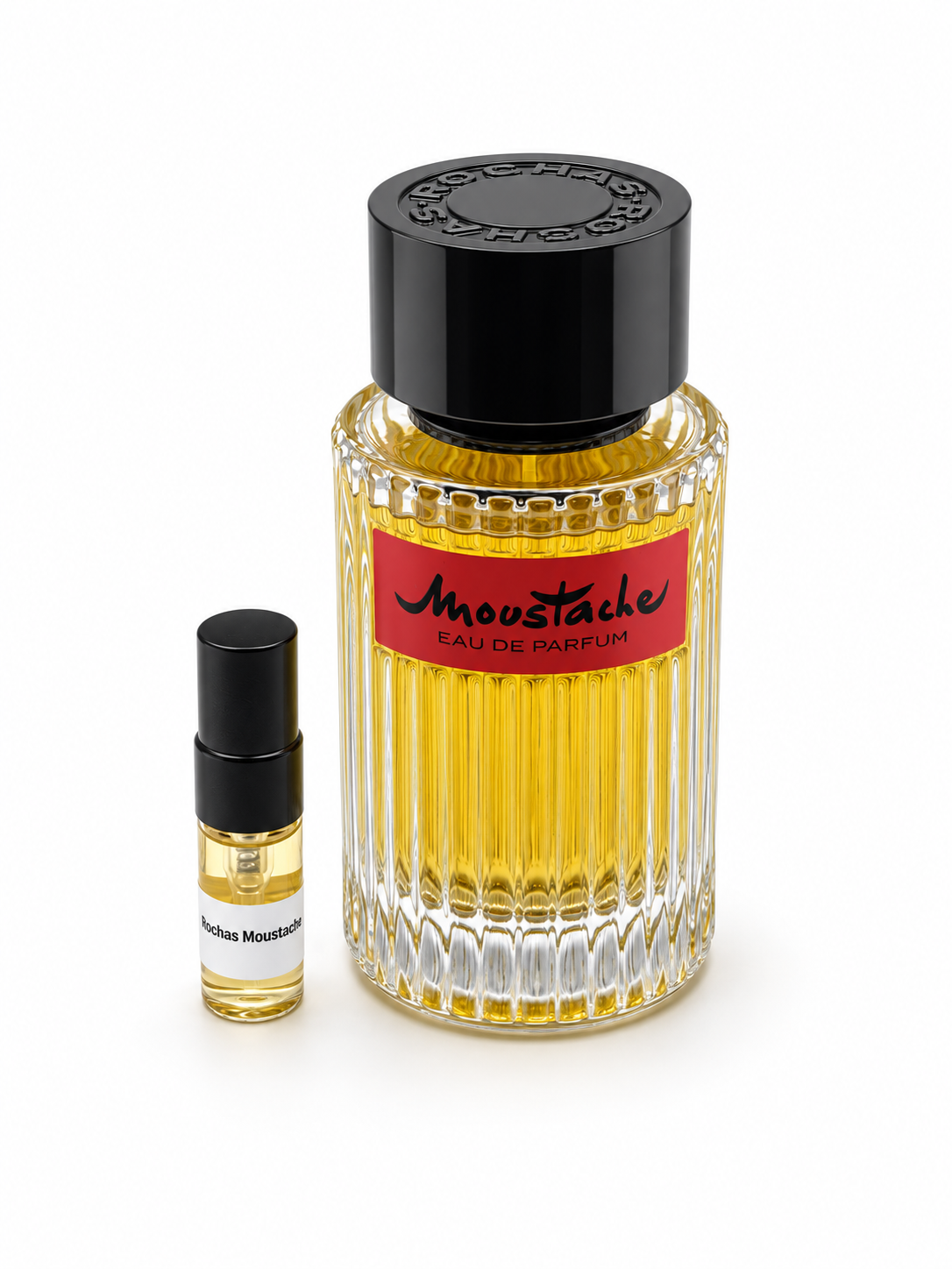 Rochas Moustache with black-capped sample vial — studio photograph